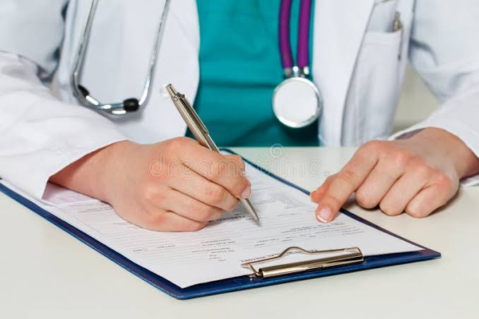 Front desk staff assisting a patient